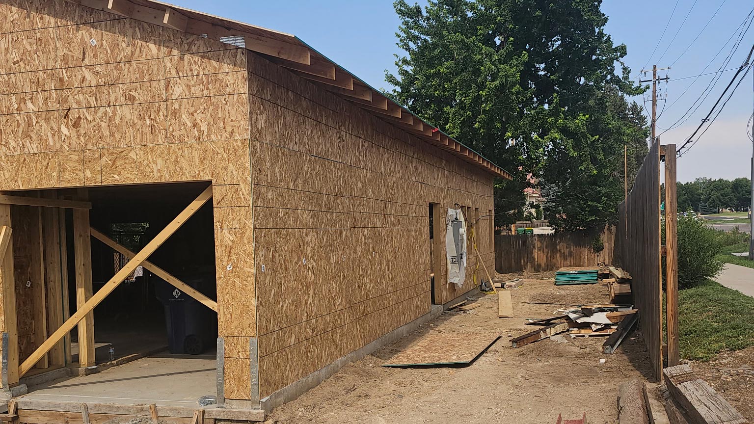 Detached garage under construction with OSB sheathing installed and the roofline framed