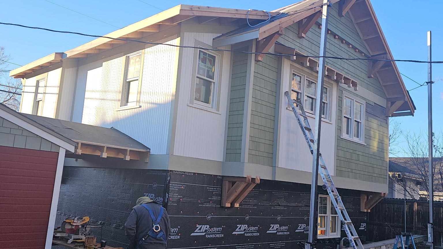 Craftsman gable with new sage green fiber-cement lap siding and white trim