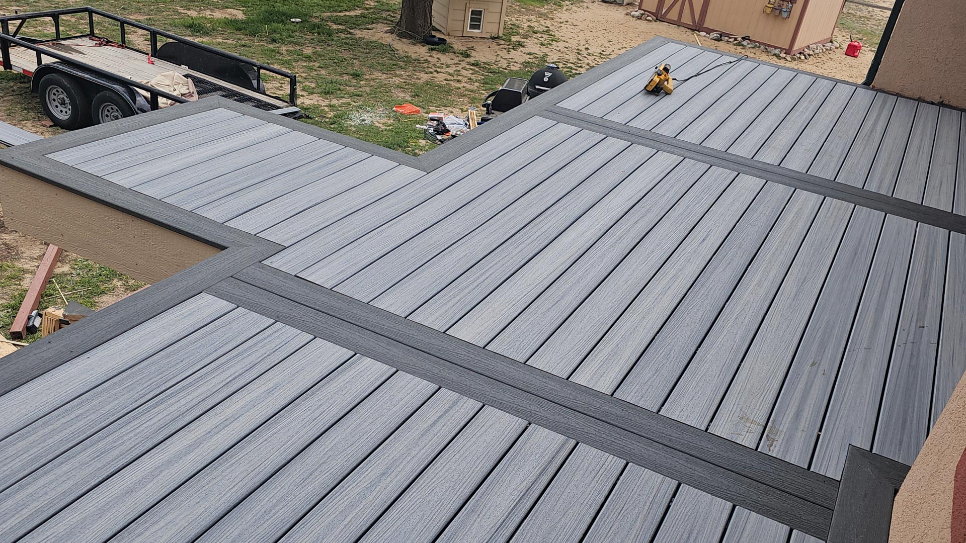 Multi-level gray composite deck with integrated stairs connecting the levels