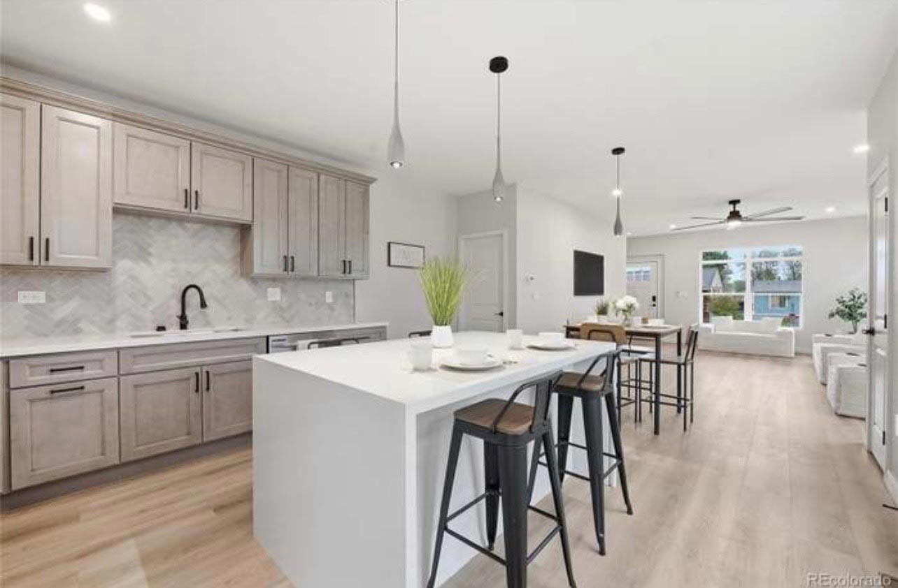 Open-concept kitchen with gray flat-panel cabinets and a white waterfall island