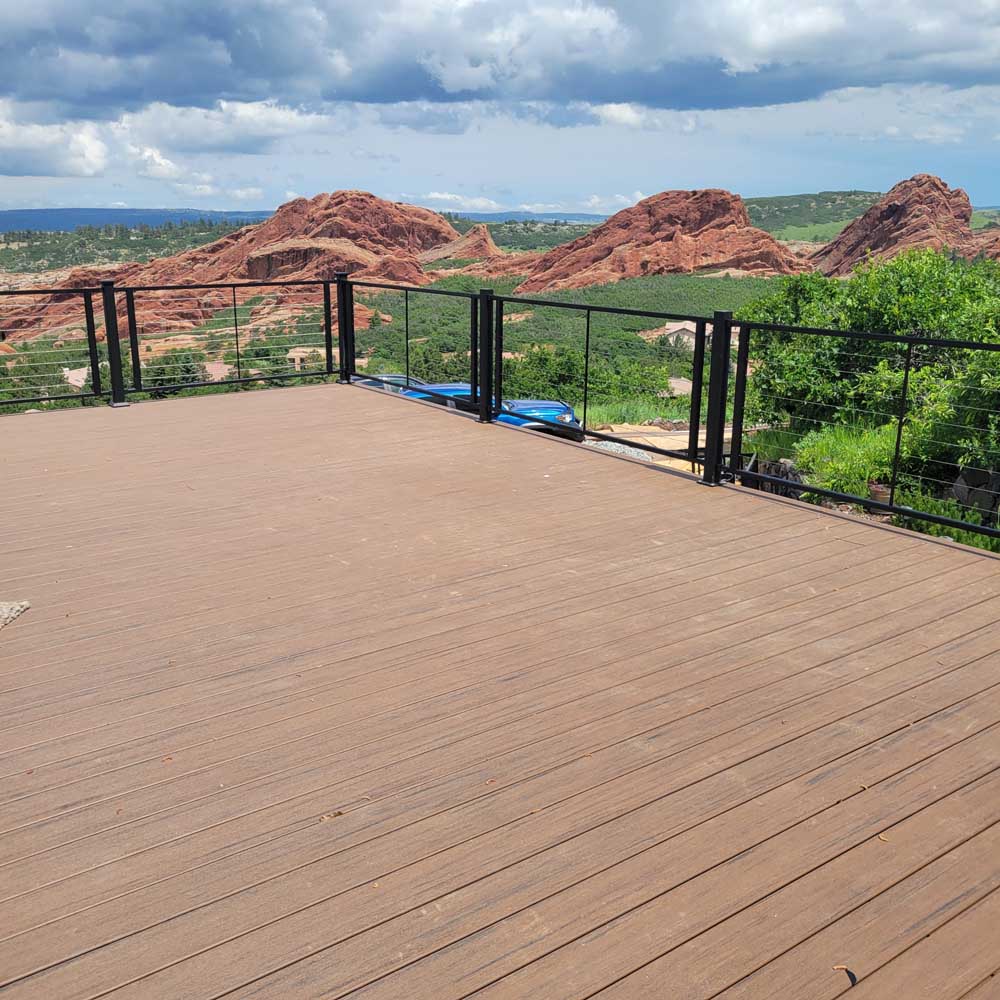 Composite deck with black cable railing with a mountain view — deck build by BH Builders, Denver metro