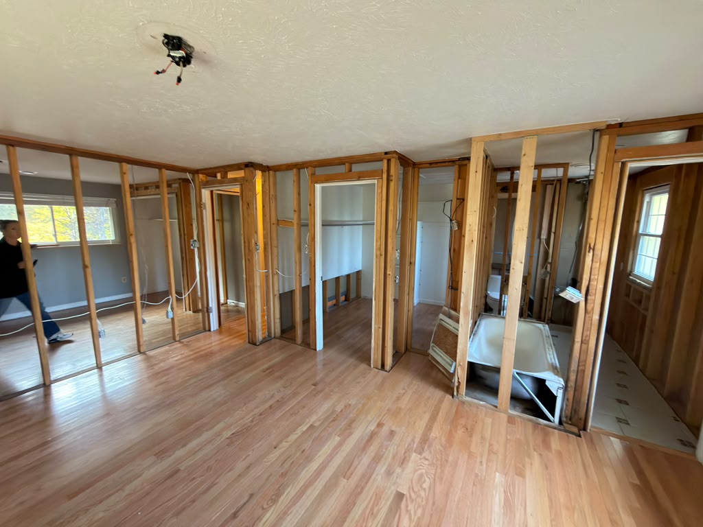 Master Bedroom Framing: Closet and Bathroom Connections Wider view of open partition framing, closet openings and the adjoining bathroom in the Denver bedroom remodel.