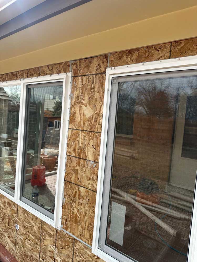 New white windows exposed OSB corner — exterior remodel by BH Builders, Denver metro
