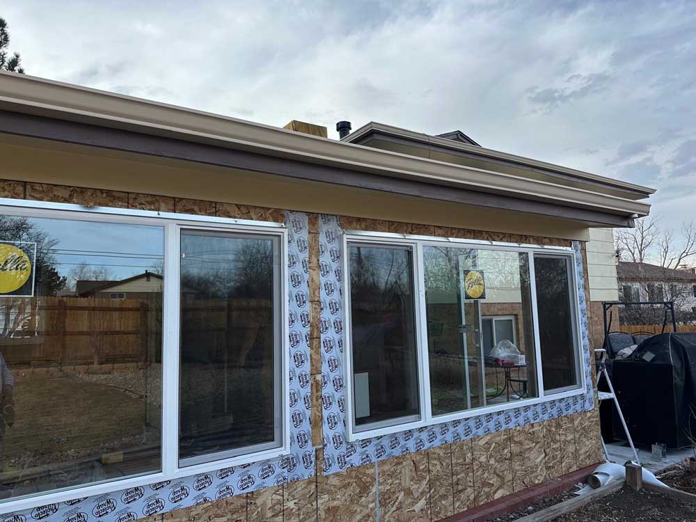 New windows house wrap corner exterior — exterior remodel by BH Builders, Denver metro