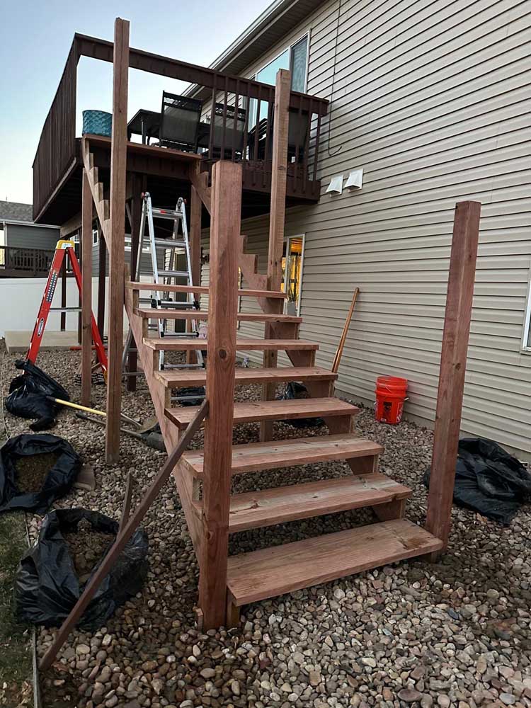 Wood deck staircase construction tan siding — exterior remodel by BH Builders, Denver metro