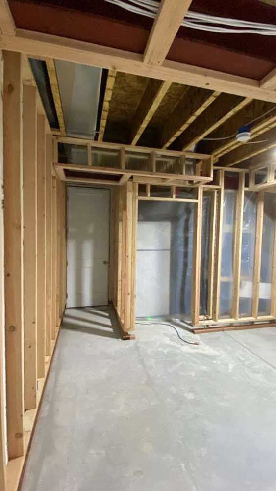 Basement framing with door openings and a soffit — the stage a basement-finish permit inspection reviews