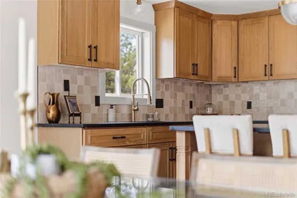 Kitchen maple cabinets tile backsplash black counters — kitchen remodel by BH Builders, Denver metro