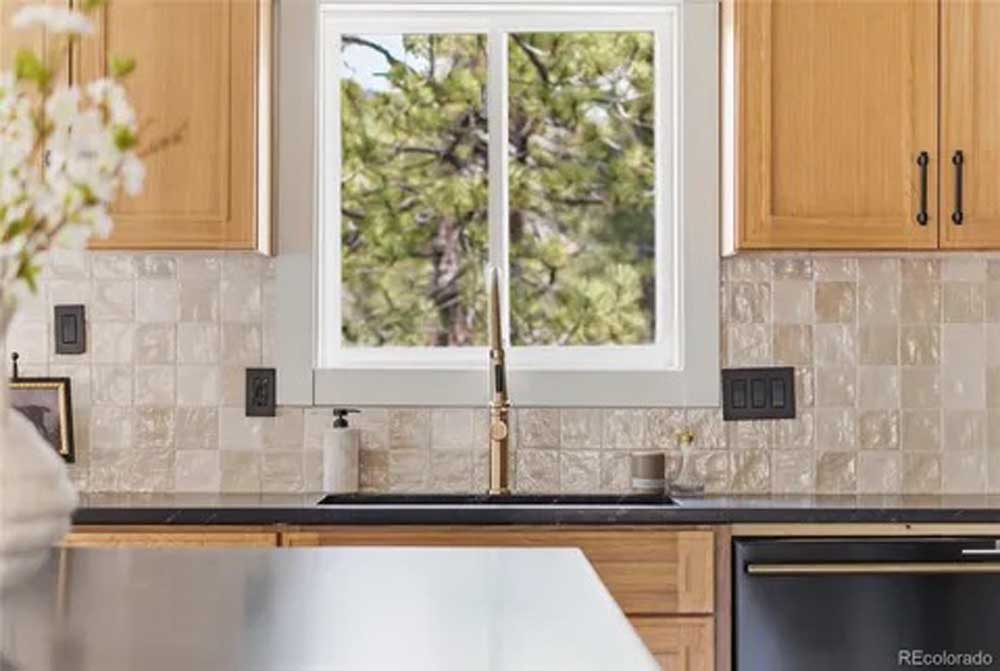 Kitchen sink window maple cabinets black counters — kitchen remodel by BH Builders, Denver metro