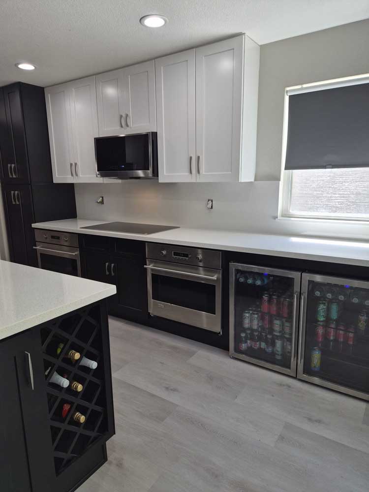 Two tone kitchen beverage fridge wine rack island — kitchen remodel by BH Builders, Denver metro