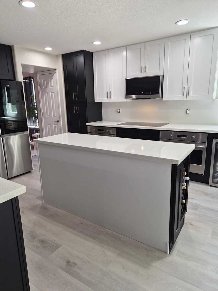 Two tone kitchen black white cabinets gray island — kitchen remodel by BH Builders, Denver metro