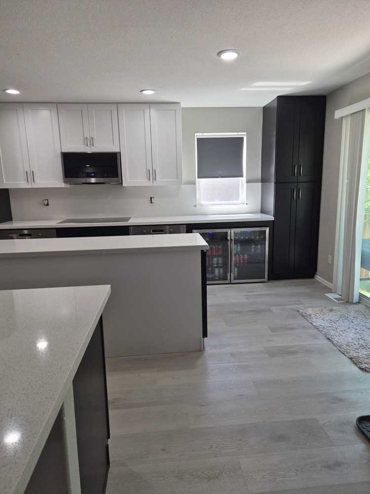 Two tone kitchen quartz peninsula beverage center — kitchen remodel by BH Builders, Denver metro