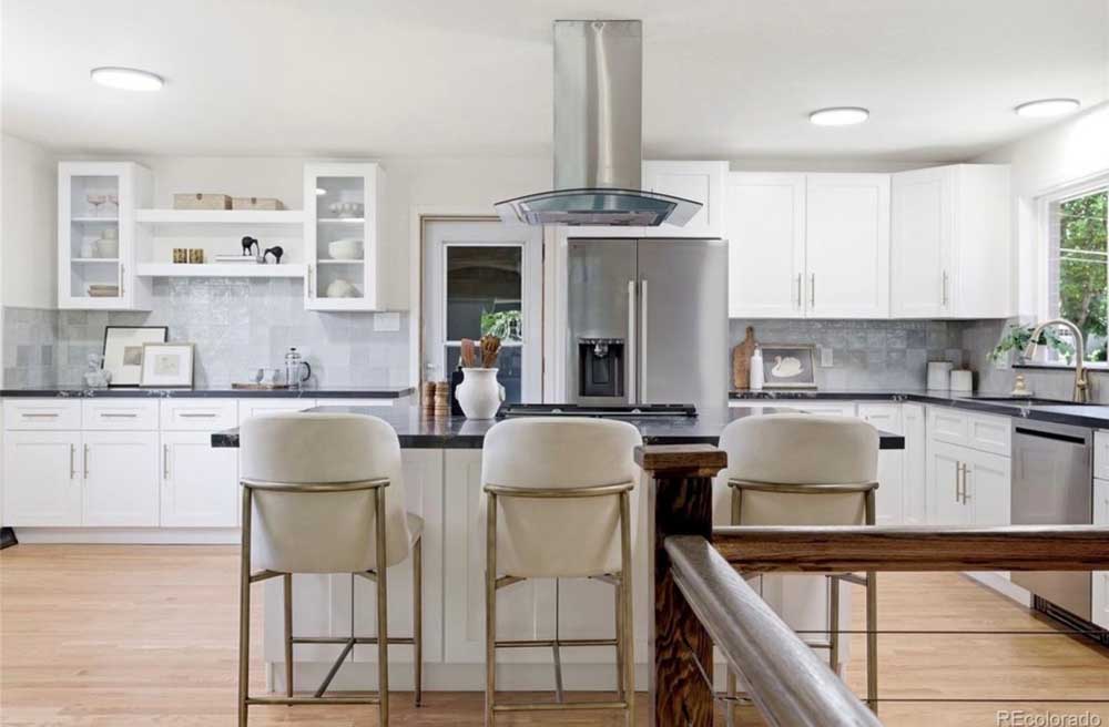 White kitchen island range hood glass cabinets — kitchen remodel by BH Builders, Denver metro