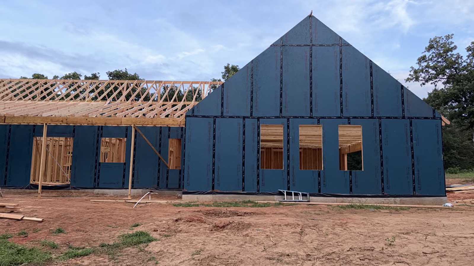 Roof trusses set on a custom home with exterior sheathing complete