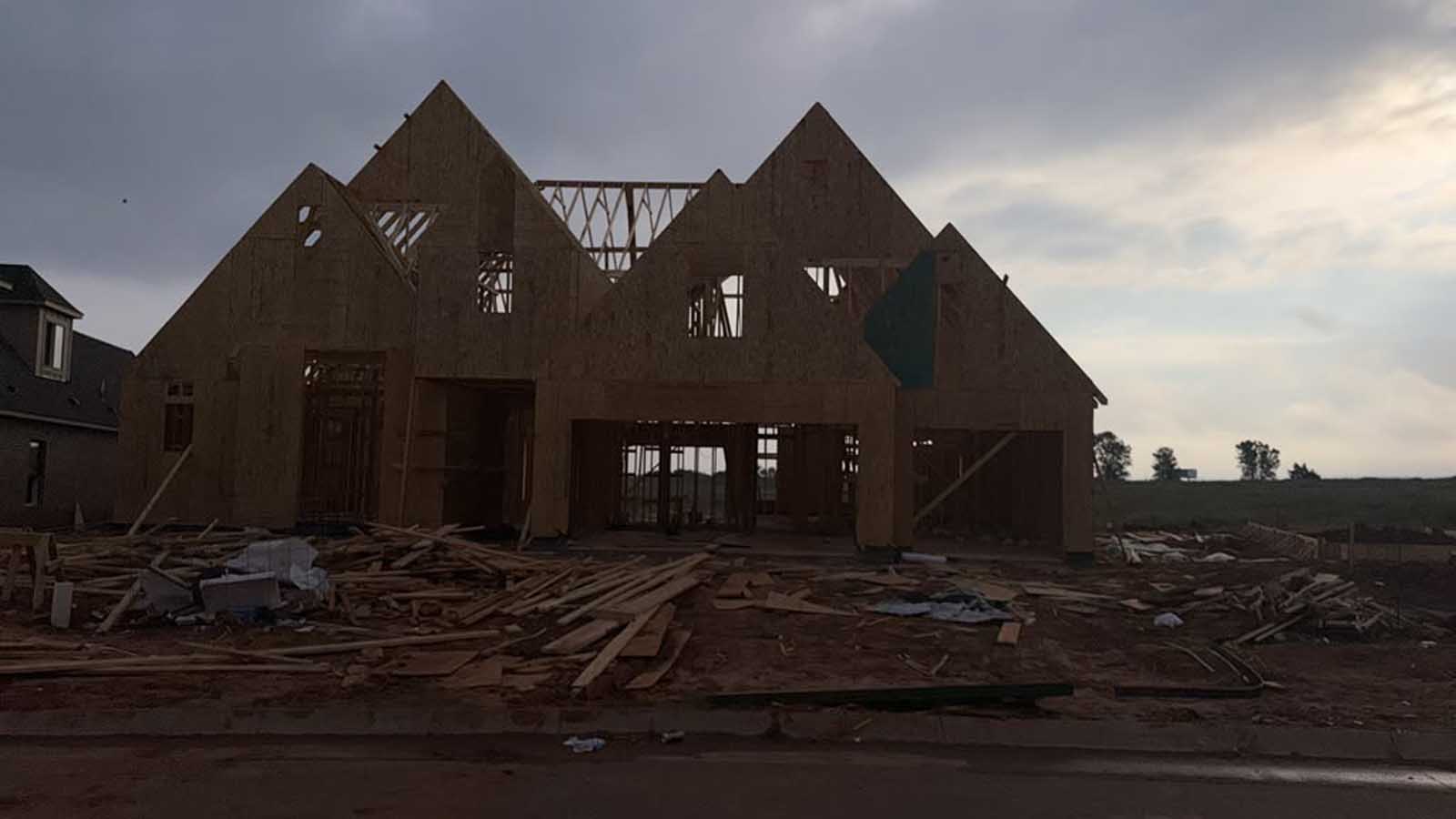 Multi-gable custom home framing in progress on a Denver-metro job site