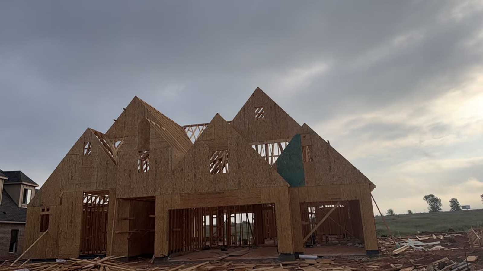 Second view of multi-gable custom home framing showing gable studs and roof planes