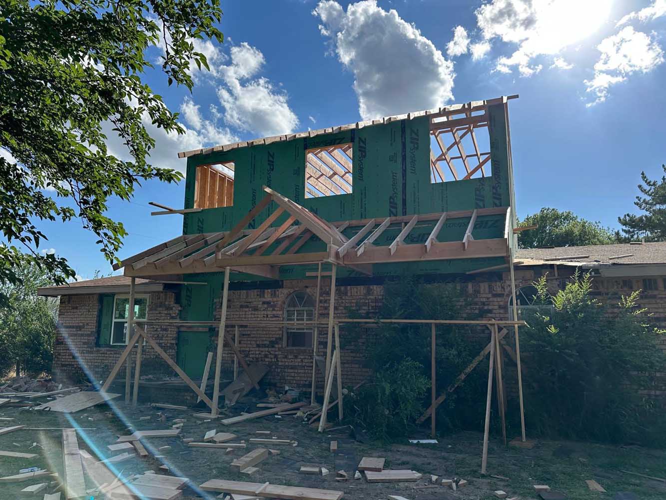 Second-story home addition framed above the original single-story structure