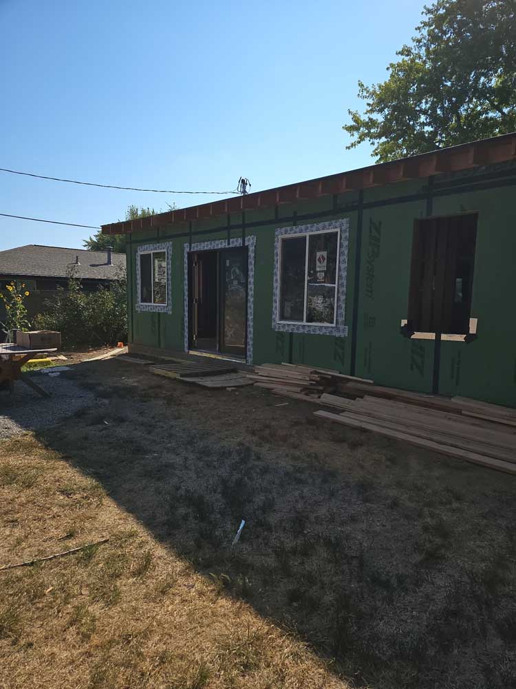 Single-story home addition with exterior sheathing installed