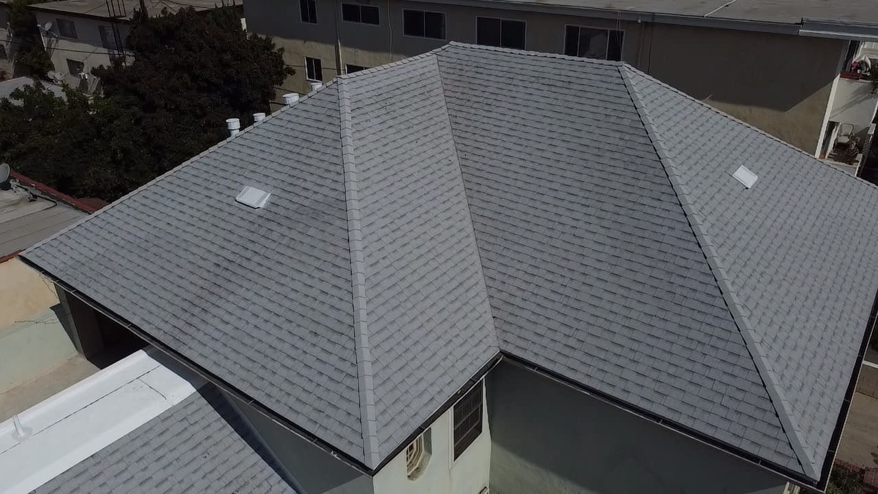 Completed architectural shingle roof with woven valleys and new attic vents