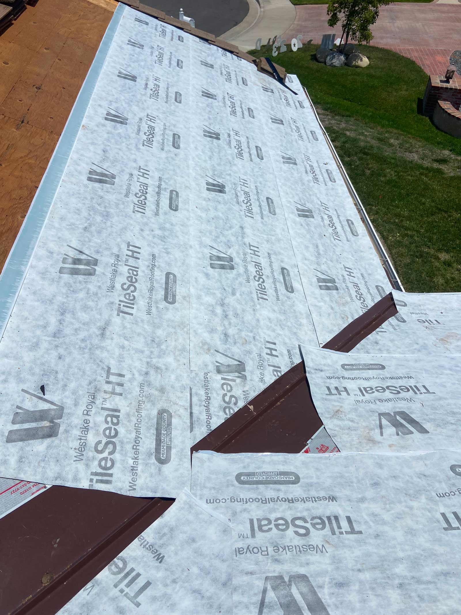 Close-up of TileSeal HT high-temperature underlayment lapped over new brown metal valley flashing