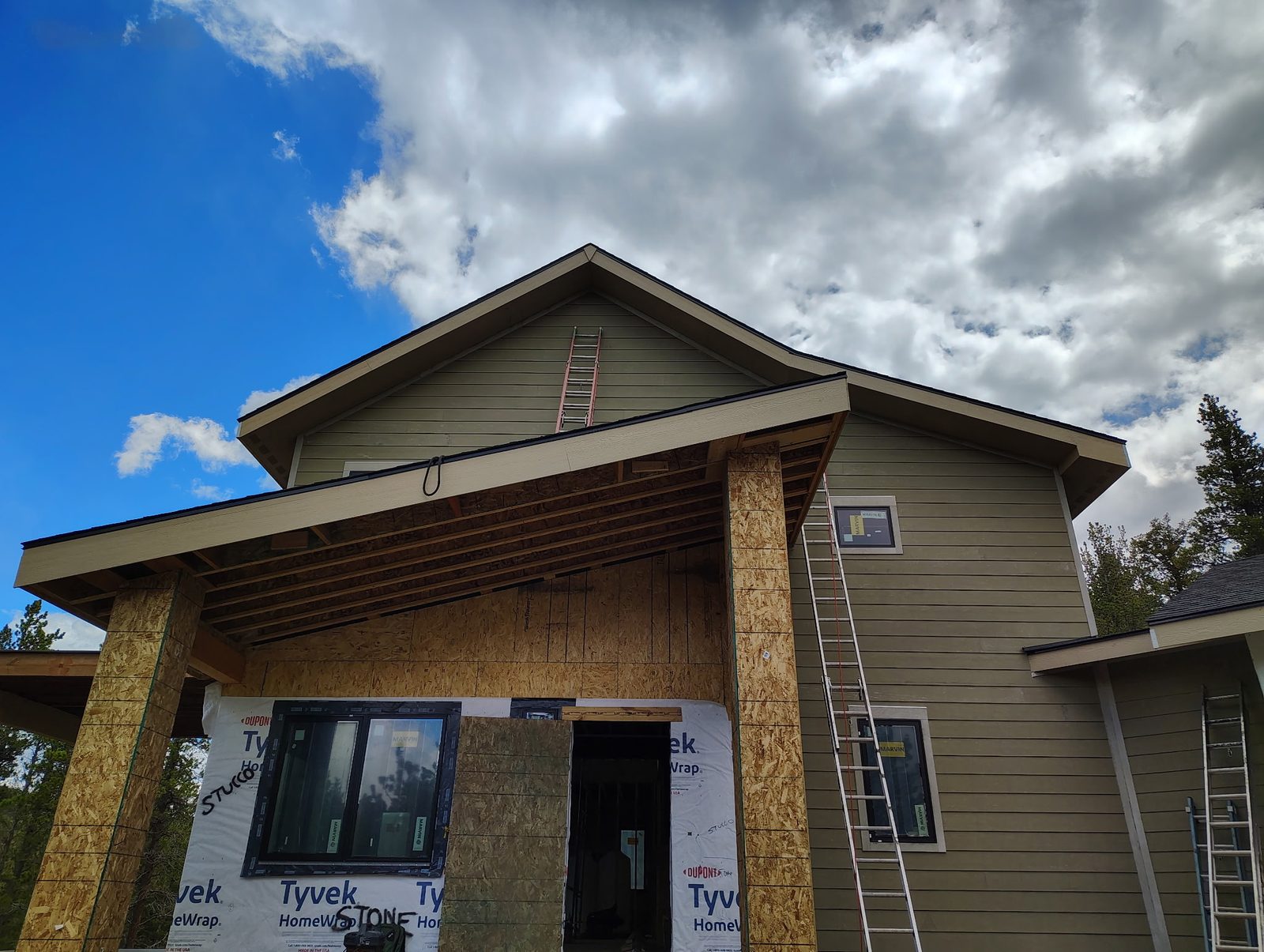 Lap siding installation olive green gable housewrap — siding installation by BH Builders, Denver metro